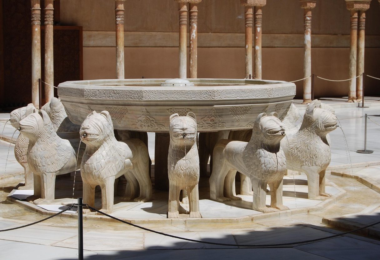 Fountain of the Lions in the Alhambra's Court of the Lions, with stone lions and slender marble columns behind