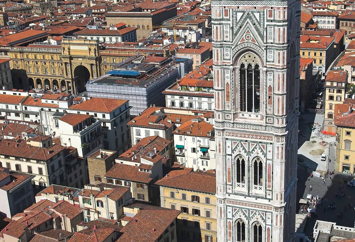 Giotto's marble bell tower seen from above, with Florence's terracotta rooftops and green hills behind