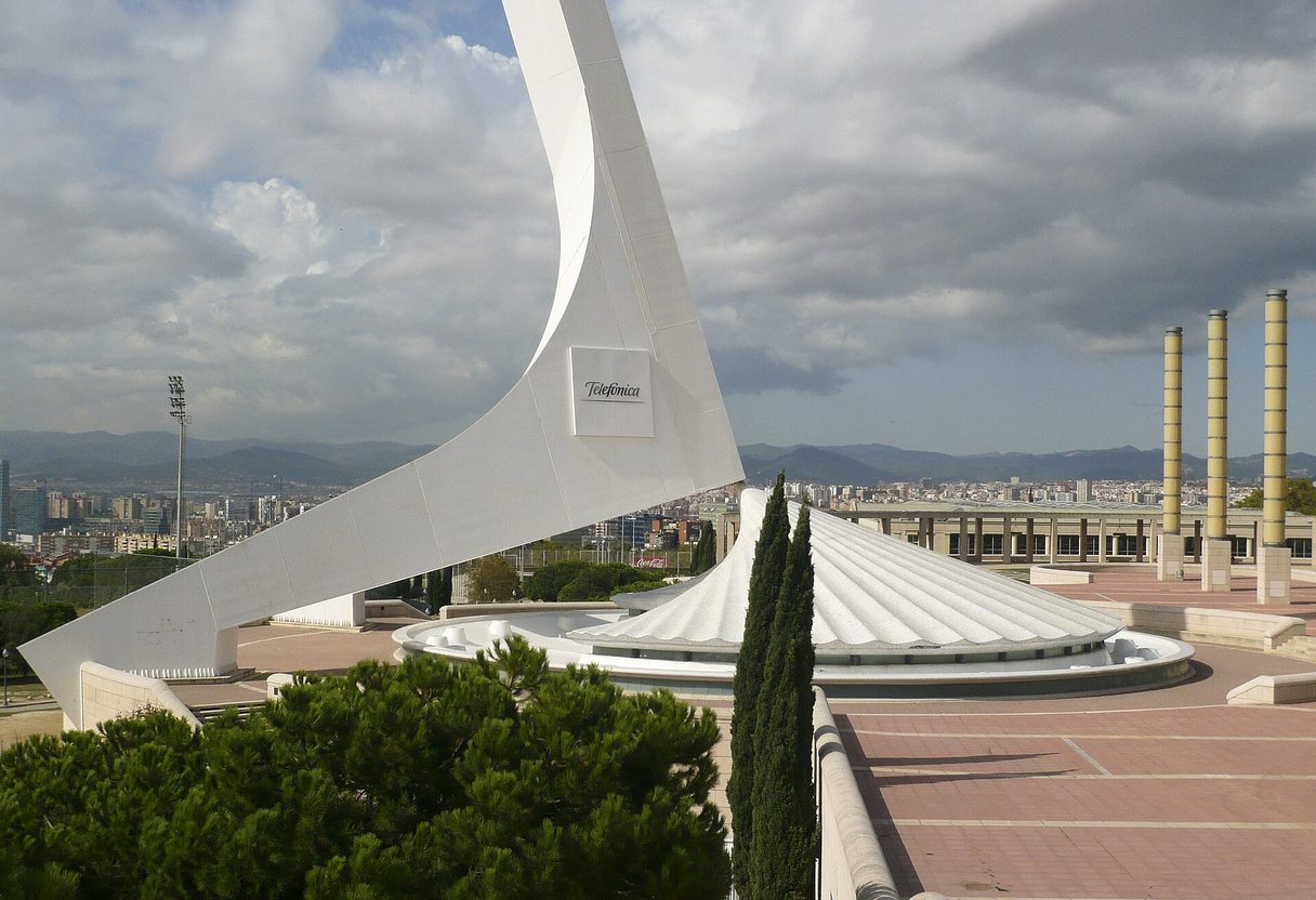 Base of the white Calatrava tower on Montjuïc's Olympic Ring with columns and city views beyond