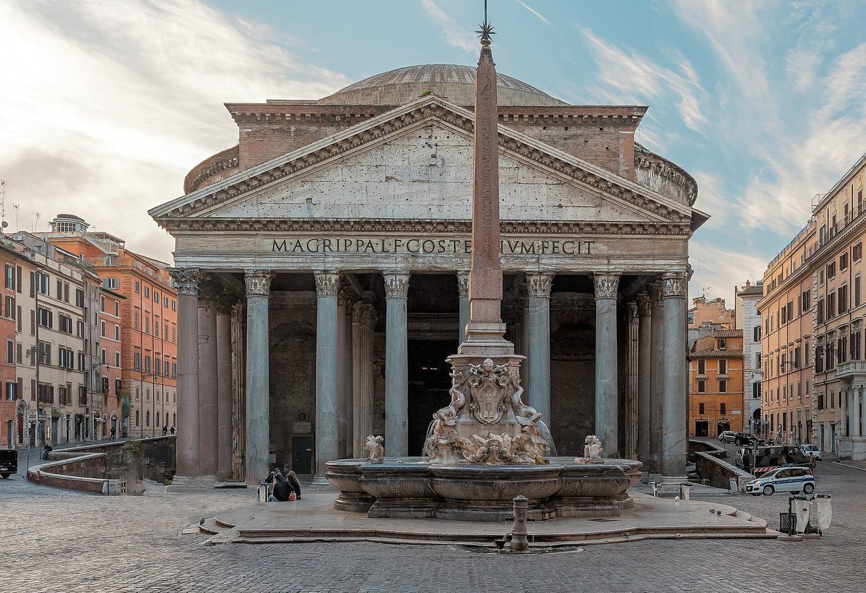Pantheon's columned portico behind the obelisk fountain in an almost empty Piazza della Rotonda at soft morning light