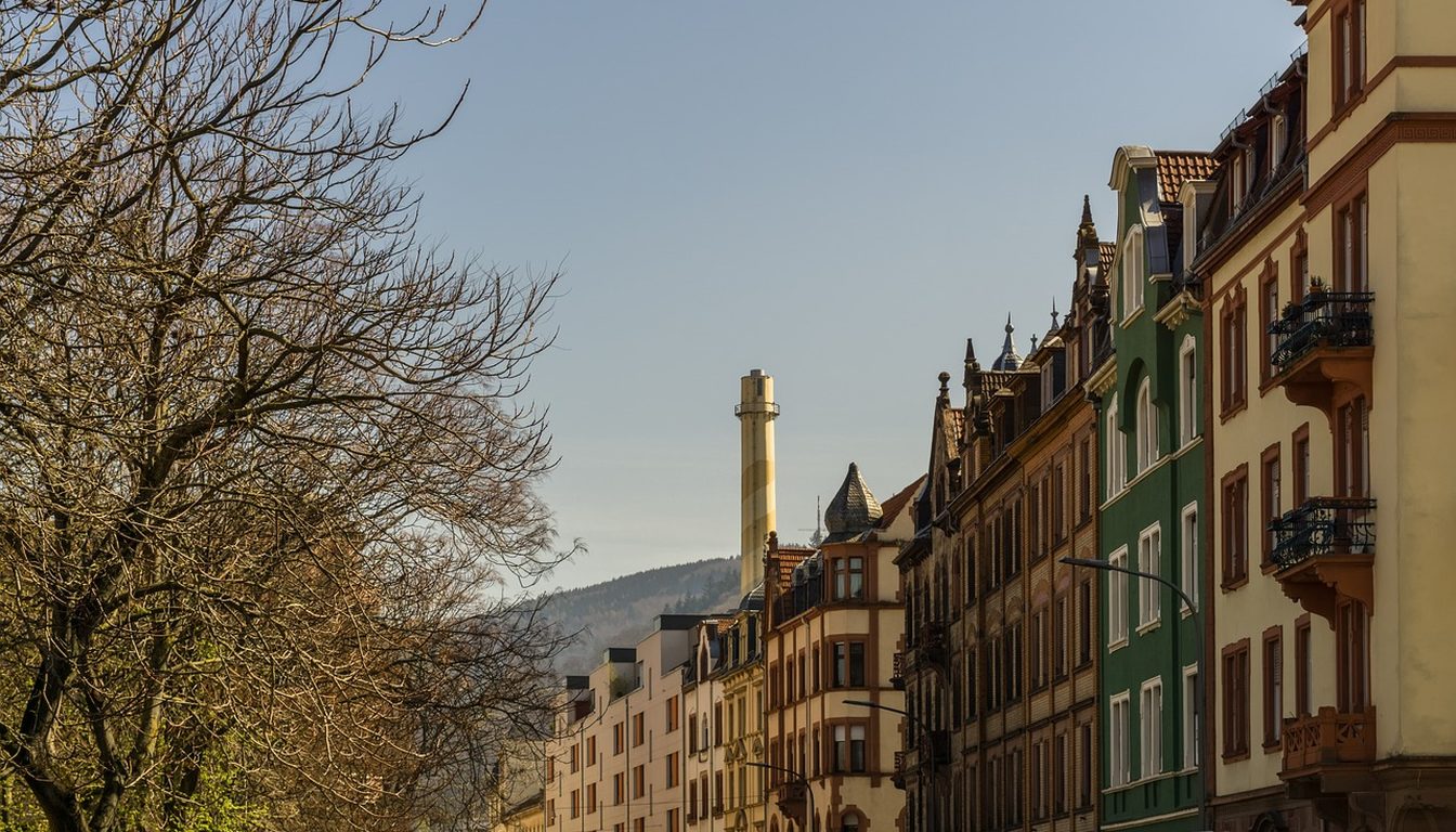 Row of colourful historic apartment buildings with balconies along a street in Heidelberg, Germany
